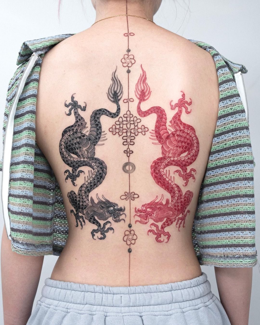 Red and black Japanese dragon backpiece tattoo by Ink District Amsterdam