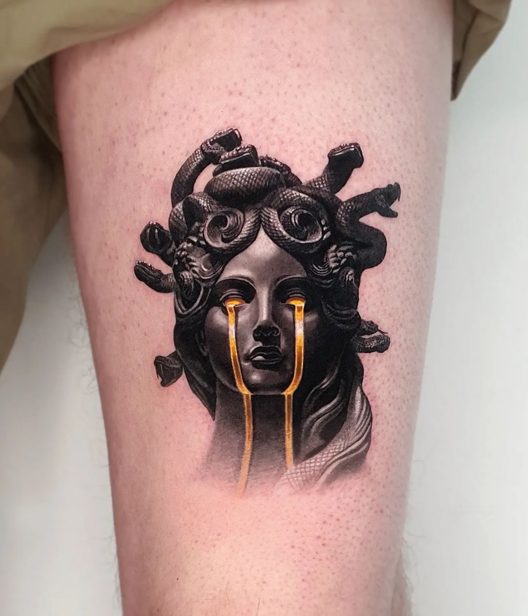 Colour realism Medusa tattoo with gold detailing by Ink District Amsterdam